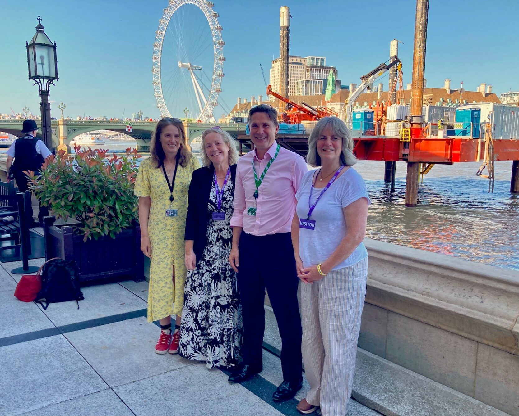 people standing by the Thames river