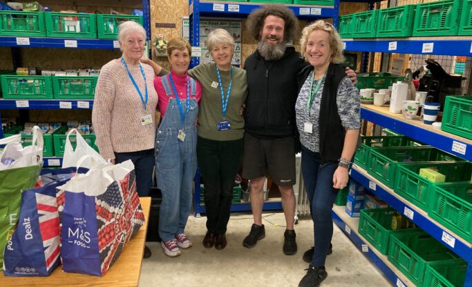 people in front of shelves with food